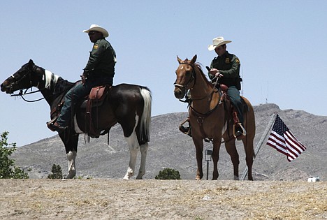 &lt;p&gt;Mounted Border Patrol Officers stand watch as the motorcade of President Barack Obama drives past before he spoke about immigration reform at Chamizal National Memorial Park in El Paso, Texas, Tuesday.&lt;/p&gt;