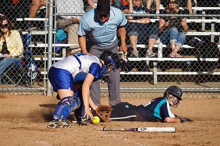 &lt;p&gt;Coeur d'Alene catcher Teigan Lockwood searches for the ball as Hailey Jackson, of Lake City, slides safely into home plate for a sixth inning score.&lt;/p&gt;