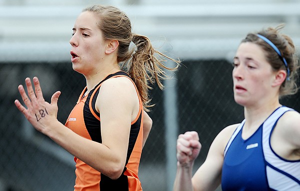 Flathead's Tess Brenneman competes with  Glacier's Maddey Freyduring the 100 trials at the Archie Roe Track Meet on Saturday in Kalispell.