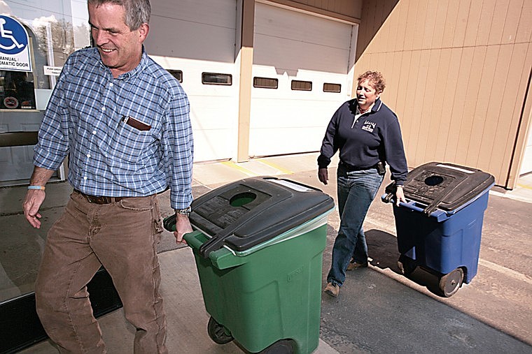 Mark Nelson and Karen Sargeant show off the new recycling bins at Polson City Hall.
