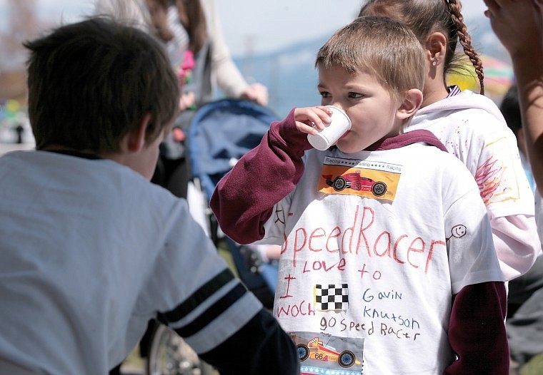 Cherry Valley kindergartener Gavin Knutson quenches his thirst at a water stop during the Polson Walk-A-Thon Friday afternoon.