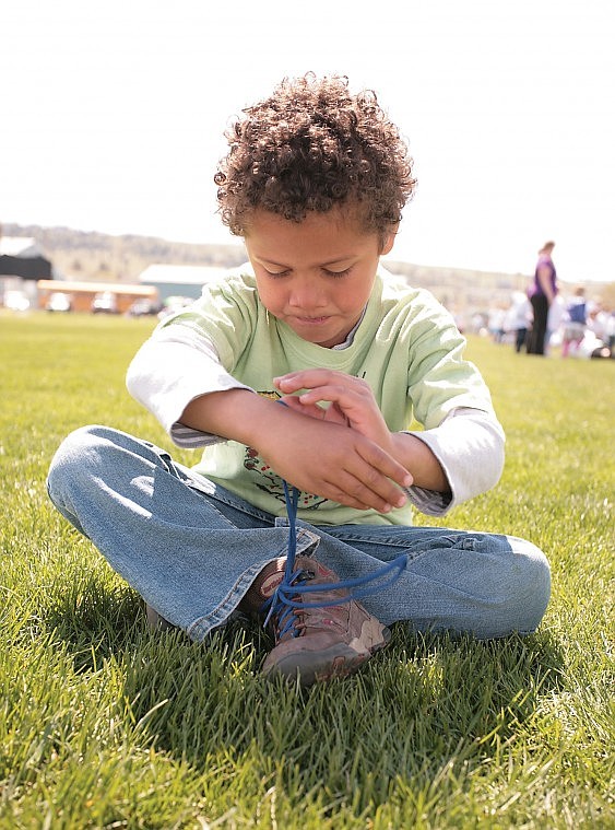 Cherry Valley Kindergartner, Traylon Thompson ties his shoes before the start of the 2010 Walk-A-Thon at Linderman Elementary. Friday, the entire student body as well as teachers, parents, and friends circled the Linderman walking path to raise money for the schools. Last year, they raised $12,500, and this year&Otilde;s goal was to beat it. The results are not yet tallied, but if the animated atmosphere was any indication of the event&Otilde;s success, new Smart Boards should be on the way.