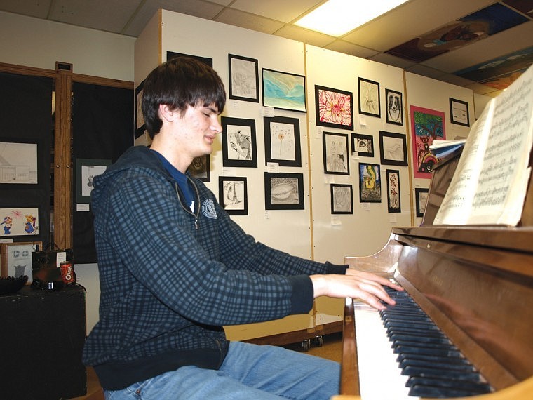 Dustin Baker, 17, is an 11th grader who loves music. It was what he decided to enter into the Plains High School Student Art Exhibit this year. During the reception, he played the piano and the attendees enjoyed the ambiance while checking out the other students' art work.