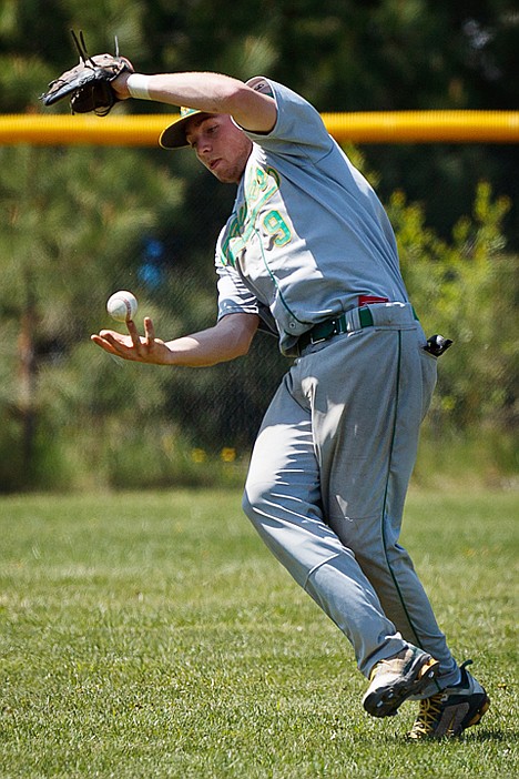 <p>Off balance, Eric Cooper attempts to catch the ball with his bare hand after losing it in the sun during 4A Region 1and 2 baseball action Saturday.</p>