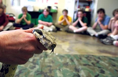 Michelle Kensbock, a vet tech at North Idaho Animal Hospital holds a red-tailed boa as part of a Science Bridge Project science lesson &#151; this one for seventh-graders from the Sandpoint Charter School. (Photo by RALPH BARTHOLDT)