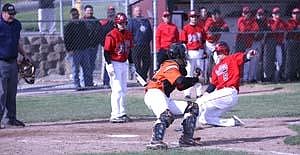 Ephrata catcher Brett Bazaldua attempts to tag Othello right fielder Jakob Scott at home.