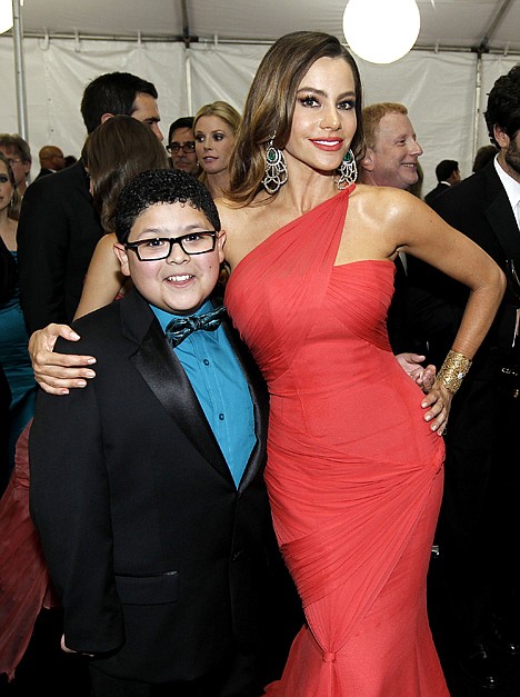<p>Rico Rodriguez, left, and Sofia Vergara pose backstage after winning the award for outstanding comedy series for "Modern Family" at the 63rd Primetime Emmy Awards in Los Angeles in September 2011.</p>