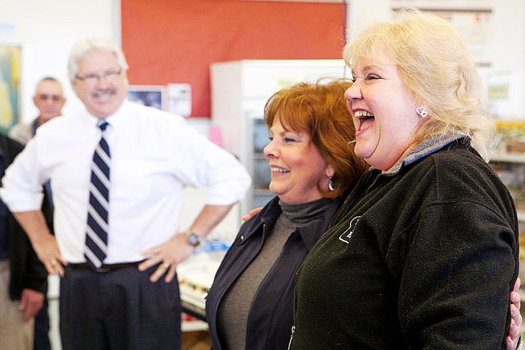 &lt;p&gt;Flathead Food Bank executive director Lori Botkin, right, laughs while making introductions before accepting a donation from Walmart general manager Lance Lerud, left, Wednesday morning at the food bank in Kalispell. The $62,500 donation was part of the Walmart Foundation's State Giving Program, a quarterly grant given to non-profit organizations. The Flathead Food Bank's grant was written by Catherine Webber, center. May 7, 2014 in Kalispell, Montana. (Patrick Cote/Daily Inter Lake)&lt;/p&gt;