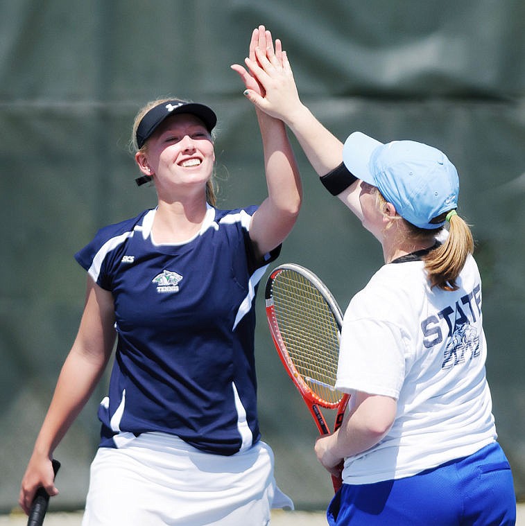 <p>Glacier's Kirstyn Haugenoe (left) and Kali Mathison high five each other after a point Thursday afternoon during the Class AA Northern divisional tennis tournament at Flathead Valley Community College. </p>