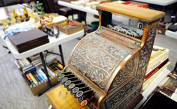 An antique register sits in a room full of items collected by Jim and Shirley Hendrick on Tuesday in Kalispell. The horse drawn buggies, antiques, furniture, musical instruments and firearms will be auctioned off on Saturday beginning at 9 a.m.