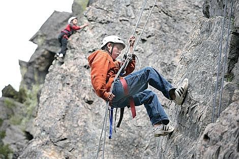 Photos by Ed Moreth Boy Scout Tanner Starkey (bottom) from Troop 57 repels to the bottom as Daniel Damschen of Troop 46 makes his way up the rock face.