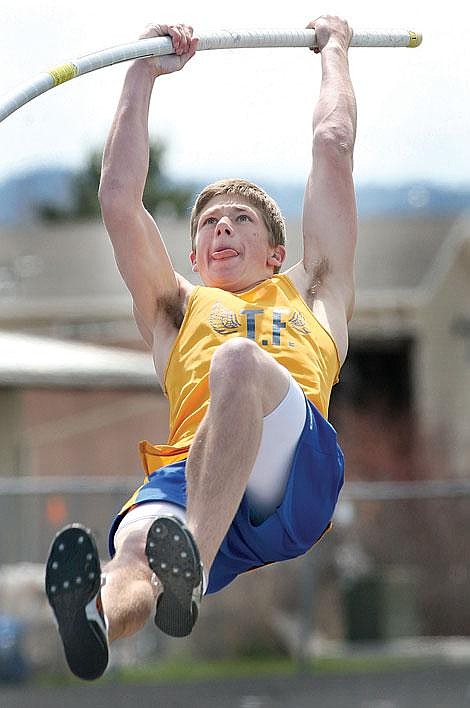 Photos by Ed Moreth Thompson Falls Bluehawk Brian Schenavar goes up to break his own pole vault record and flies over the 15-foot bar at the District 8B competition at Kalispell Saturday.