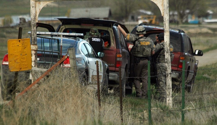 Law enforcement prepare to enter the residential area housing Justin Seely who was arrested and charged with assault with a weapon.