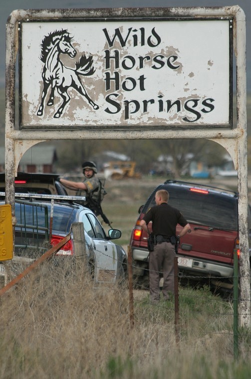 Law enforcement prepare to enter the residential area housing Justin Seely who was arrested and charged with assault with a weapon.