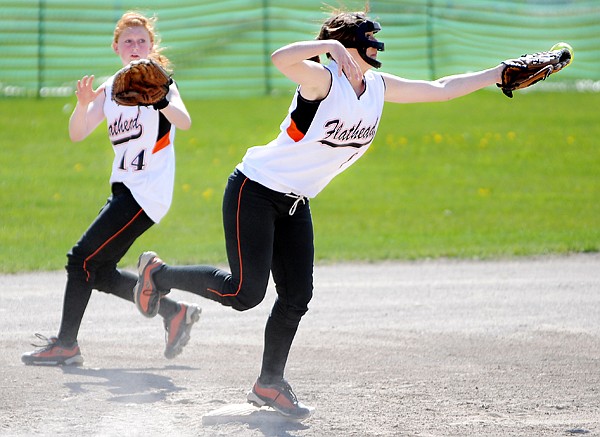 Flathead shortstop Casey Roylston just misses the ball at second base during the first crosstown softball game with Glacier on Thursday at the Conrad Complex.