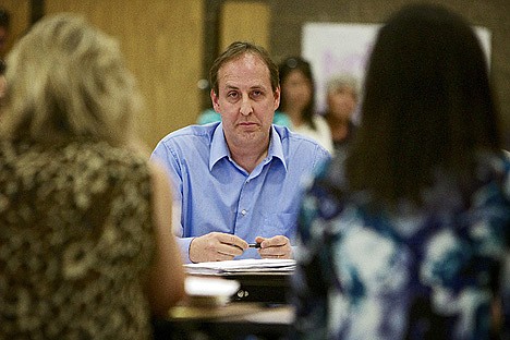 &lt;p&gt;Coeur d'Alene Education Association representative Tim Sandford listens to the Coeur d'Alene School Board trustees present their position on the budget during a negotiations meeting Tuesday at Woodland Middle School.&lt;/p&gt;