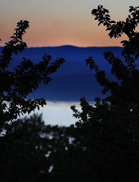 &lt;p&gt;Flathead Lake at sunset Monday is framed by cherry trees at O&#146;Fallon Orchard.&lt;/p&gt;