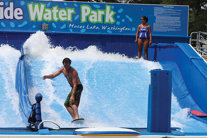 A surfer navigates the Flowrider at the Surf 'n Slide Waterpark in August 2011. Working at the pool teaches various life lessons, park employees said.