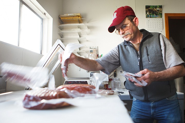 &lt;p&gt;Don Clapper, owner of Don's Country Smokehouse, sorts through a variety of meats and sausages Tuesday afternoon in the processing area of his shop in east Evergreen. Clapper has won several state cured meat championships.&lt;/p&gt;