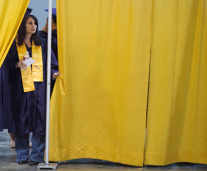 &lt;p&gt;Jamie Newman looks out from behind the curtain of the staging area before Flathead Valley Community College's graduation ceremony Friday night at the Flathead County Fairgrounds.&lt;/p&gt;