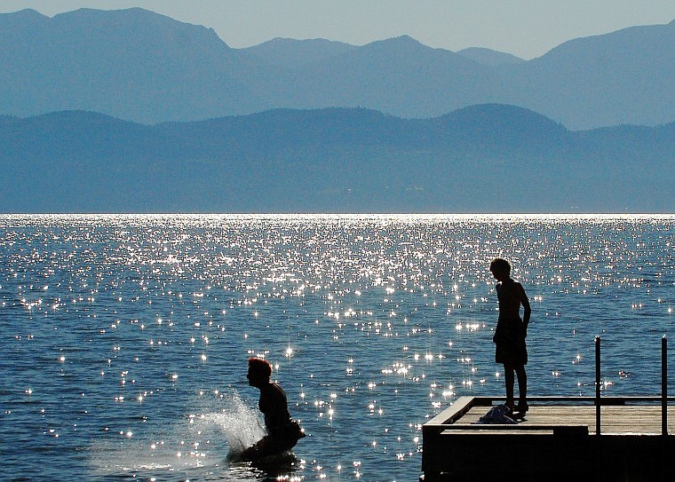 Kirsten Raas jumps into Flathead Lake while her son Kellen looks on from  Lakeside&#146;s public dock. The two were taking full advantage of the clear weather before driving back to Edmonton, Alberta, where it had been rainy.