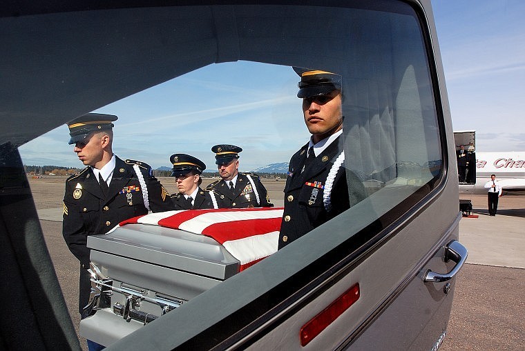 Montana National Guard Honor Guard members carry the body of Army PFC Nicholas Cook to a hearse at Glacier Park International Airport. Cook died in Afghanistan on March 7, 2010, when insurgents attacked his unit.