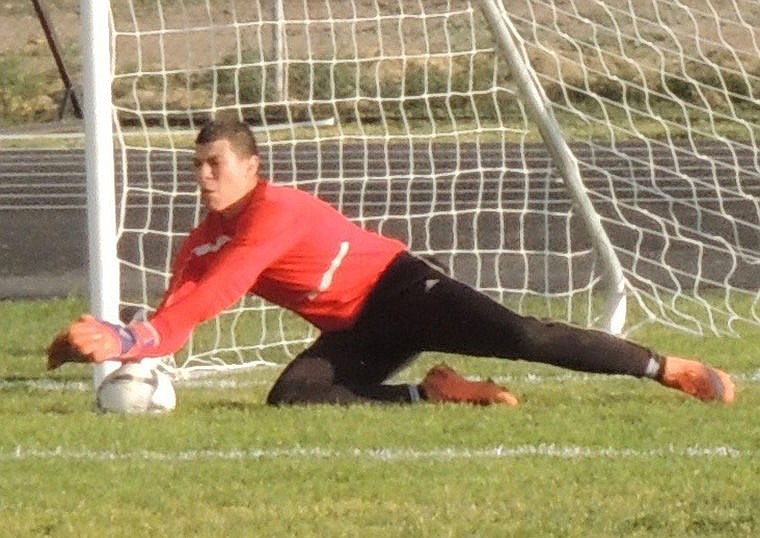 Royal goal keeper Carlos Quintero dives to smother a Mabton attempt and keep the score at 1-0 in the first half.
