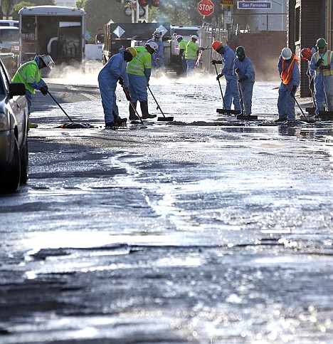 &lt;p&gt;Crews sop up the remains of about 10,000 gallons of crude oil in the Atwater Village section of Los Angeles on Thursday. A geyser of crude spewed 20 feet high over approximately half mile into Los Angeles streets and onto buildings early Thursday after a high-pressure pipe burst.&lt;/p&gt;