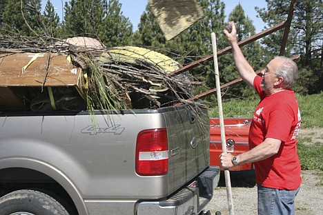&lt;p&gt;Joe Threadgill, partner in Keller Williams Realty Coeur d'Alene, tosses a piece of wood into the back of a dump-bound pickup as agents and management in the office clean up the Little Folks Preschool and Kindergarten on Thursday.&lt;/p&gt;