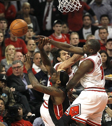 &lt;p&gt;Chicago's Luol Deng, right, blocks the shot of Miami's LeBron James as Joakim Noah watches during the first quarter in Game 1 of the NBA Eastern Conference finals Sunday in Chicago.&lt;/p&gt;