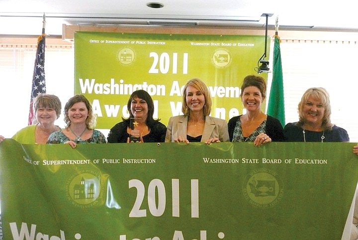 (From left) Melinda LeGrand, fifth grade teacher and Title I coordinator; Janet Dearborn, special education teacher; Michelle Jewell, computer lab paraprofessional; Noreen Thomas, Sage Point Elementary principal; Ronda Fuller, kindergarten teacher and Moses Lake Superintendent Michelle Price display the first-ever award won by Sage Point Elementary.