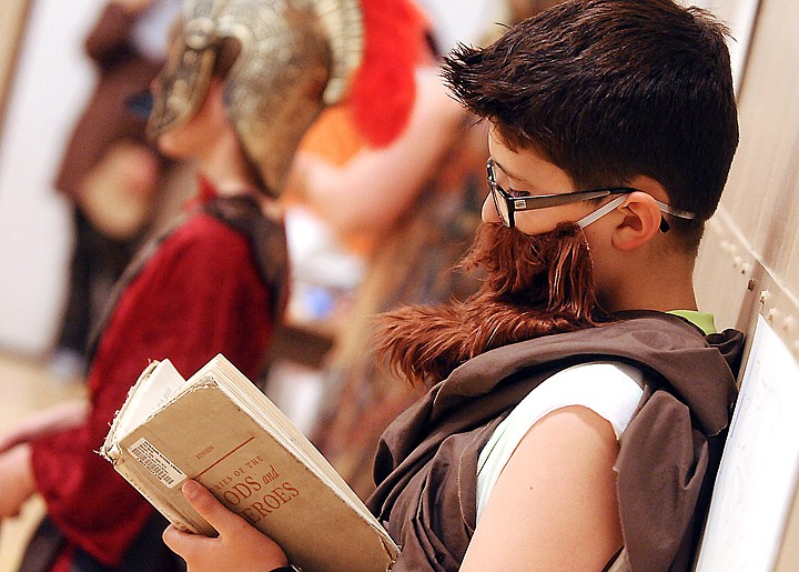 <p>Conner Bullins as Aristotle poses with a copy of Stories of the Gods and Heroes by Sally Benson at the Annual 5th Grade Wax Museum at Peterson Elementary School on Wednesday, May 14, in Kalispell. (Brenda Ahearn/Daily Inter Lake)</p>