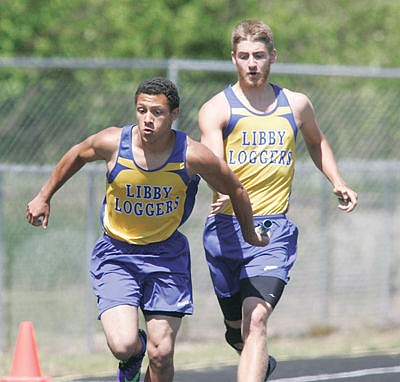 &lt;p&gt;Dominic Voorhies hands off to Cole Walker in the boys 4x100 Saturday during the district track meet May 14.&lt;/p&gt;