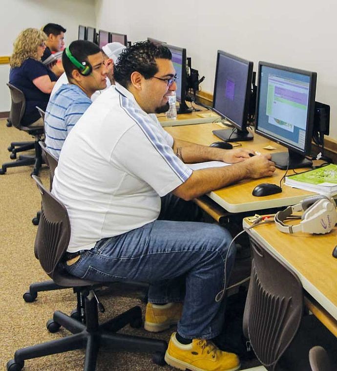 Students use computers in the math lab to work on problems. The college's Emporium program has improved outcomes in math.