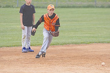 &lt;p&gt;Xavier Fisher charges a slow roller while taking some reps at third base.&lt;/p&gt;