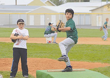 &lt;p&gt;Nick Cleveland of Polson goes into his wind-up while Charlo's Riley Hutchin studies his technique.&lt;/p&gt;