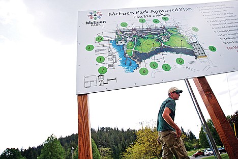 &lt;p&gt;Nick Goodwin walks behind one of three McEuen Park information boards installed Thursday in the park. The signs contain information about the project cost and features that will be added once the project is completed.&lt;/p&gt;