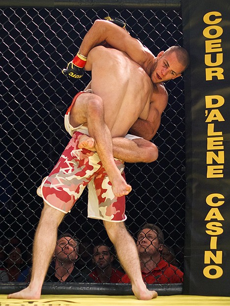 <p>Jordon Cook climbs his opponent Jacob Harkness for position Thursday night.</p>