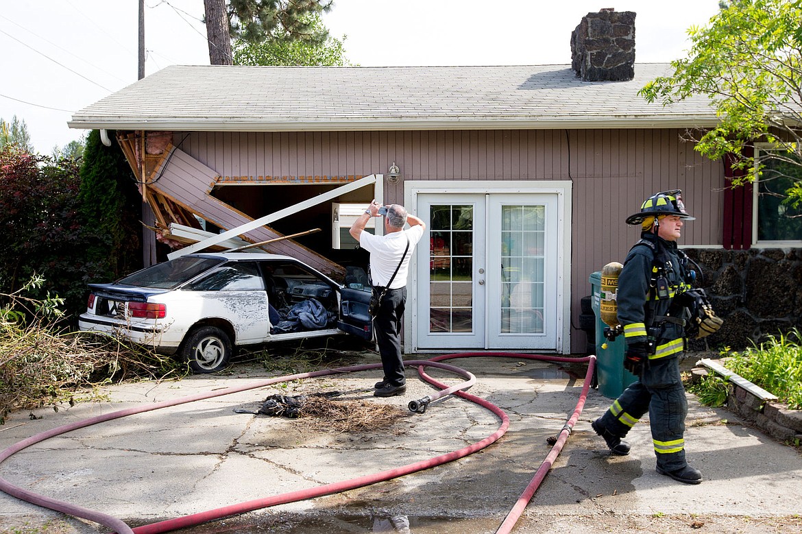 &lt;p&gt;Fire officials from Northern Lakes Fire Protection work the scene of a home that was crashed into during a police chase on Tuesday on Wright Street in Rathdrum.&lt;/p&gt;