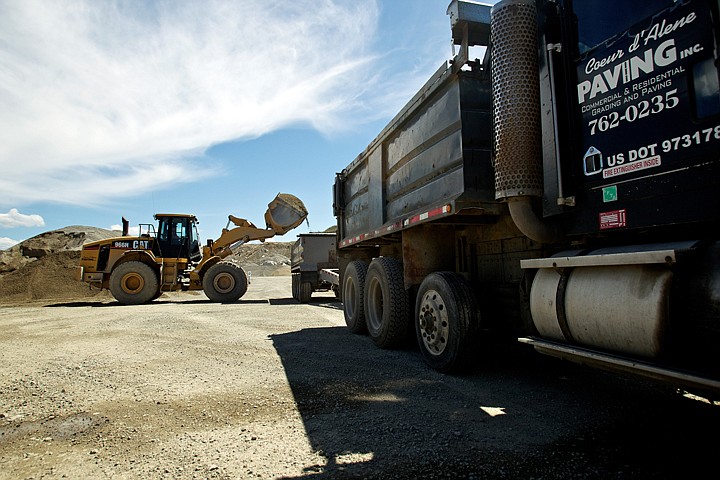 &lt;p&gt;A front loader pours material into the a trailer bed Wednesday at Coeur d'Alene Paving's facility near Rathdrum. Coeur d'Alene Paving is requesting a permit and zone change in order to relocate its asphalt batch plant from its Highway 53 location to a site near the Stateline Speedway.&lt;/p&gt;