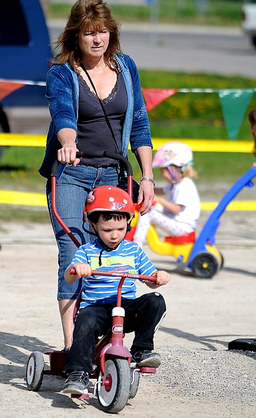 <p>Cathy Nash and Cameron Buxton, 3, make their way around the track at the Trike-a-thon for St. Jude's Children's Hospital on Wednesday morning, May 16, at Kidz in Motion Childcare center.</p>