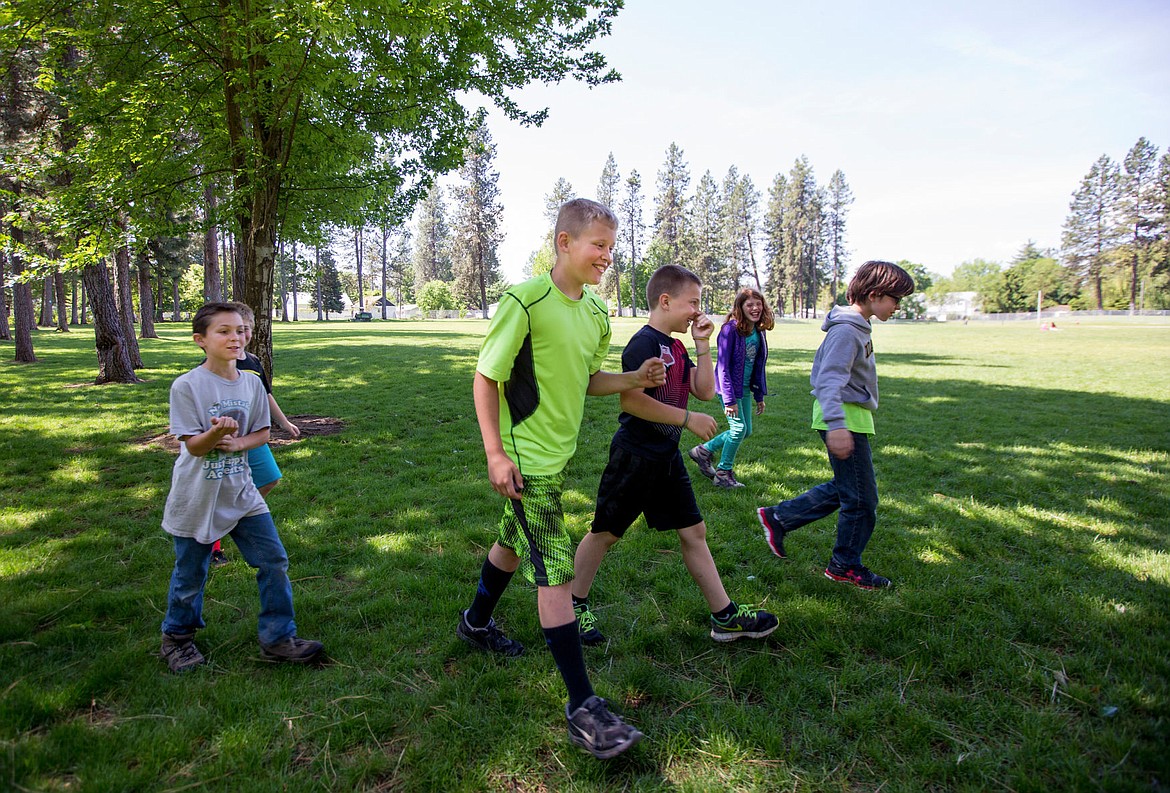 &lt;p&gt;Alex Green, center, walks with his classmates on Wednesday at Fernan STEM Academy on the site of a proposed extension to the school's existing playground.&lt;/p&gt;