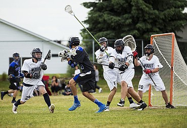 <p>LOREN BENOIT/Press Coeur d'Alene's Harrison Davies is swarmed by Lake City Wolves defenders as he tries to score during a lacrosse match, Wednesday, at Lake City High School.</p>