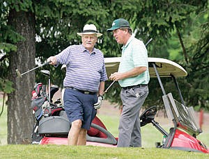 &lt;p&gt;Chuck Racicot, left, and John Graham study the green on No. 2, a 356-yard par 4 during the Ben Graham Memorial Golf Tournament Saturday.&lt;/p&gt;