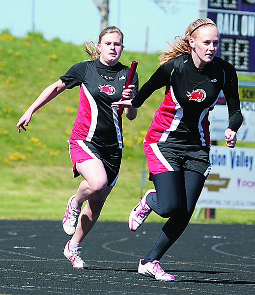 Monica Binder hands the baton off to MacKenzie Wood at Polson.