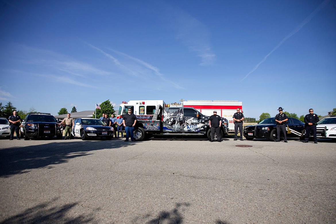 &lt;p&gt;Law enforcement officials from Coeur d'Alene, Post Falls, Idaho State Police, Rathdrum, Kootenai County Sheriff's office and the Coeur d'Alene Fire Department pose on Wednesday during a ceremony for an ATRN Towing and Recovery tow truck, center, that is dedicated to fallen first responders.&lt;/p&gt;