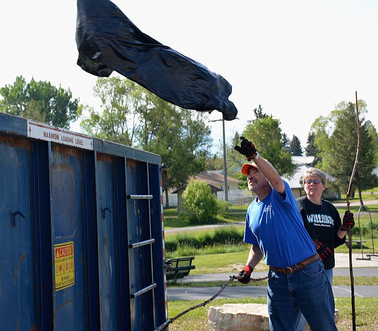 &lt;p&gt;Willard and Julie Moore of Ronan clean up trash along the city park stream, then throw it into a donated dumpster.&lt;/p&gt;