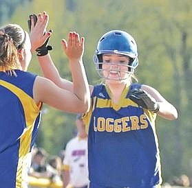 Paul Sievers/The Western News Emily Monroe exchanges high-fives with Amber Grubham after hitting a two-run homer in the bottom of the fifth inning Friday against Columbia Falls.