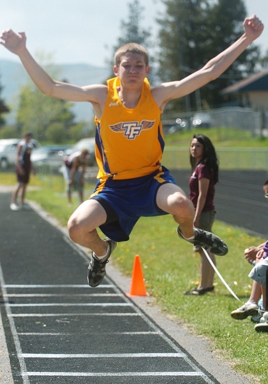 Preston Chubert soars in the long jump.