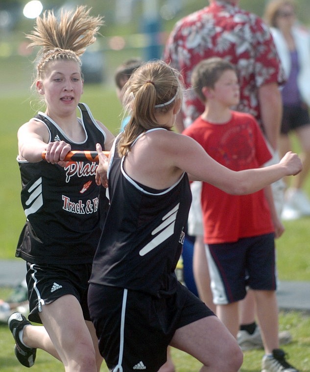 Sierra Joner hands the baton off to Kelsey Beagley at the District Track Meet in Bigfork.